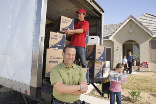 Man with van worker using safe lifting and protective equipment